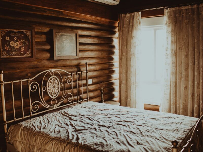 A simple bedroom with white linen and morning light