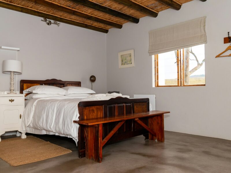 A simple farm cottage bedroom with a bedside lamp
